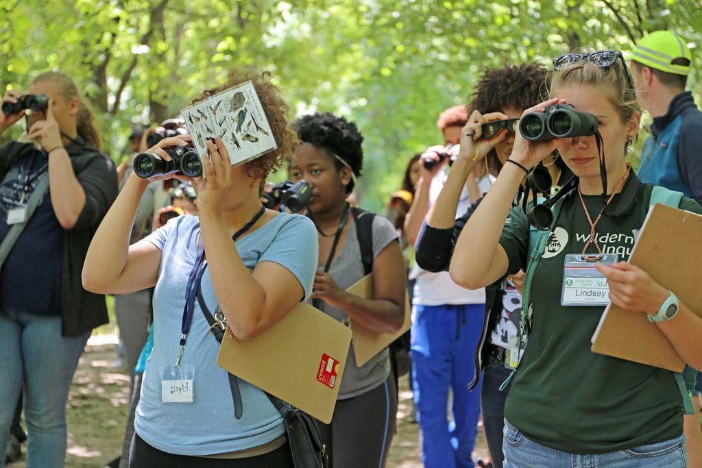 Students look for birds during the Adventures in the City session.